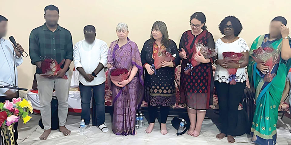 Helen Cobham, third from right, prays during her short-term mission trip to India. The obscured faces are to protect the identities of the Indian believers.