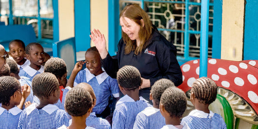 Janine Stellatos with children in Kenya