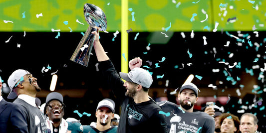 Nick Sirianni holds the Super Bowl trophy aloft as Jalen Hurts, left, looks on